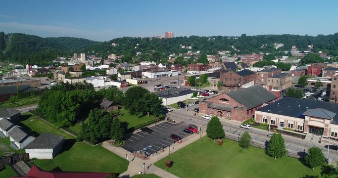 A slow forward aerial establishing shot (DX) of the small rust belt Ohio town of Steubenville on the Ohio River.  	