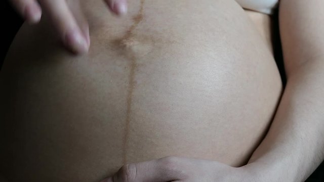 Pregnant Woman Touching Hand On Stomach