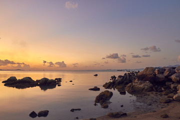 Fototapeta na wymiar Colourful sunset over sea bay on a tropical island