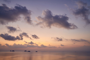 View from the top of the mountain to the sea and the islands against colourful tropical sunset