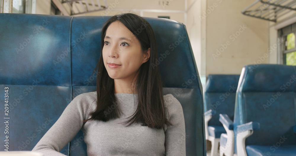 Canvas Prints Woman taking train and looking out of the window