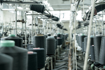 Fototapeta premium Old sewing manufacture, a factory, shop, a manufactory in work, a thread, machine tools.Old sewing manufacture, a factory, shop, a manufactory in work, a thread, machine tools.