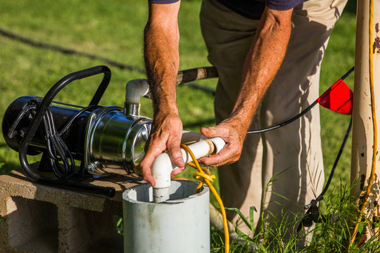 Man repairing sprinkler pump and system