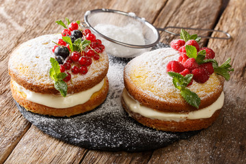 homemade sandwich Victoria cake with fresh berries and mint closeup. horizontal