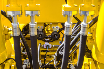 Close up of pipe system of hydraulic valves in agricultural machinery