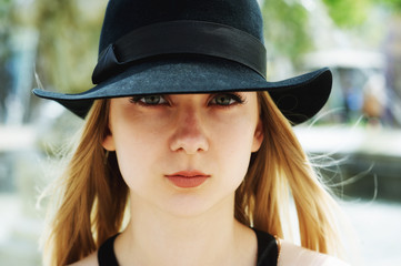 Portrait of a young woman in a hat close-up