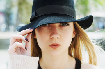 Portrait of a young woman in a hat close-up