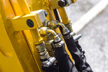 Close up of pipe system of hydraulic valves in agricultural machinery