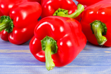 Fresh peppers lying on purple boards, concept of healthy nutrition