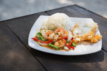 Rice topped with stir-fried shrimps and basil