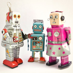 three retro toy robots together