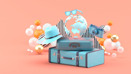 A suitcase under the globe surrounded by a camera and hat on an pink background.-3d rendering.