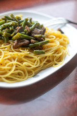 Large White Plate with Hot Delicious Pasta with Meat and Green Beans