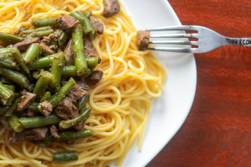 White Plate with Delicious Pasta with Meat and Green Beans, View From Above