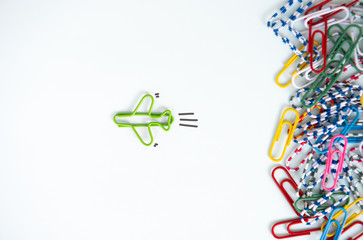 Business concept for group of stacked paperclip with another one green plane paperclip is point to...