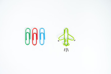 Business concept for group of stacked paperclip with another one green plane paperclip is point to another direction as a team leadership