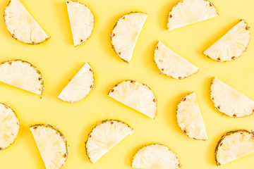 Pineapples on yellow background. Summer concept. Flat lay, top view