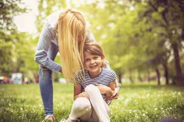 Fototapeta premium Happy mother with daughter on meadow.