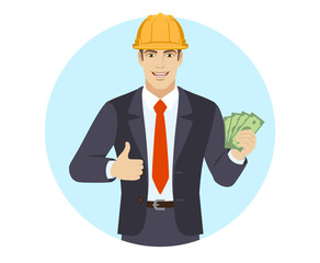 Businessman in construction helmet with cash money and showing thumb up