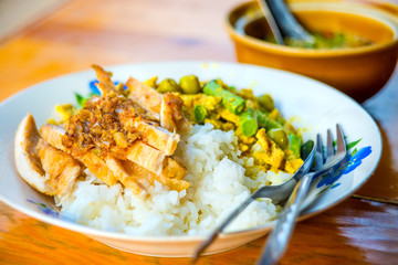 Green curry spicy chicken cuisine with long bean, coconut milk in Thai call Kaeng Kiew Wan Kai and fried pork with garlic pepper on rice favorite delicious Thai food