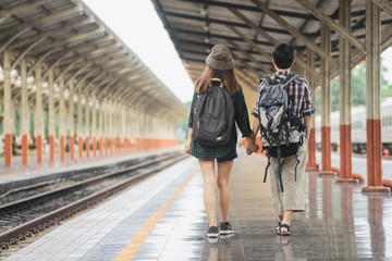 Happy young couple on railway station platform