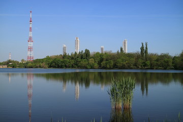 Image of a television tower on the shore of a pond.