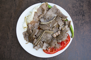 iskender kebab on a wooden surface at a restaurant top view.
