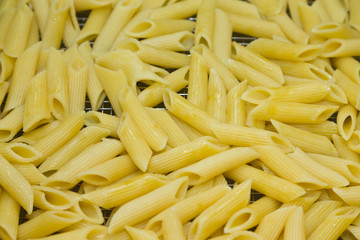 Many pasta pieces on a metal background. Selective focus. Shallow depth of field