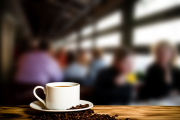Coffee in a cup on wooden table opposite a defocused  background. Collage. Selective focus