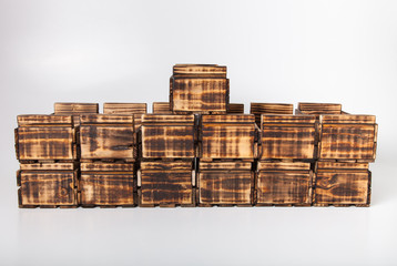 Handmade burned wooden boxes on a light background