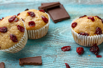 Muffins with cherry on a blue background, horizontal