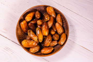 Date fruits on the white wooden table. Top view