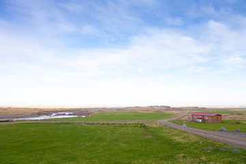 Small wooden house on the shore of the fjord in the east of Iceland