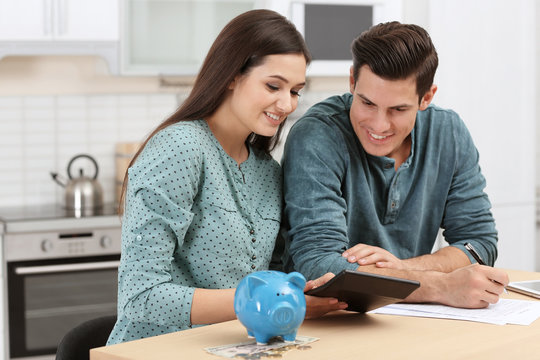 Young Couple Discussing Pension Plan At Home