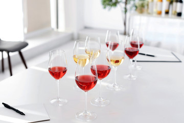 Glasses with delicious wine on table indoors