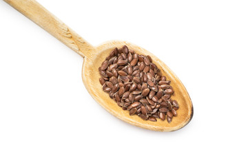 Wooden spoon with linseed or flax seed from lower left isolated on white background