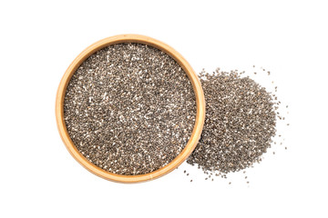 Chia seeds in a wooden bowl with a small pile to the right seen from above isolated on white background