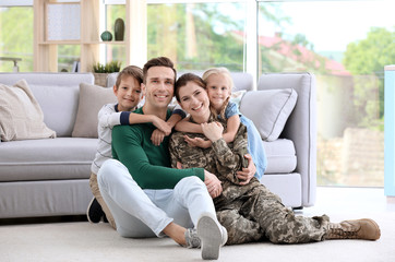 Woman in military uniform with her family at home