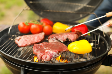 Modern grill with meat and vegetables outdoors, closeup