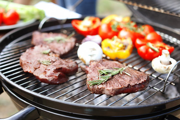Modern grill with meat and vegetables outdoors, closeup