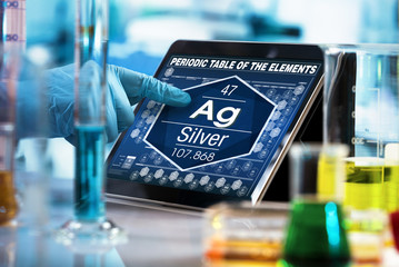 Scientist working on the digital tablet data of the chemical element Silver Ag / researcher...