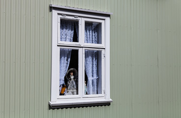 Small window on a plastered wall of rustic house
