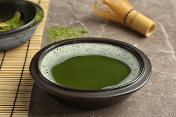 Chawan with fresh matcha tea on table