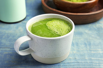 Cup of fresh matcha tea on table