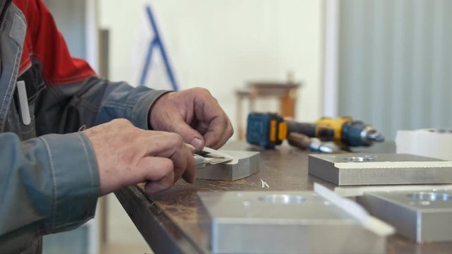 Man working with metal object for manufacturing industrial CNC machinery