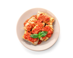 Stuffed cabbage leaves with minced meat and rice in tomato sauce on white background