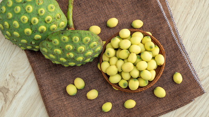 Green lotus seeds on a wooden table.