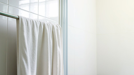 White towel hanging in a bathroom.
