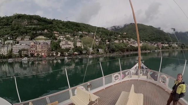 Tourist ship sails along the Lake Geneva to the Chillon Castle.