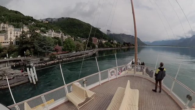 Tourist ship sails along the Lake Geneva to the Chillon Castle.
